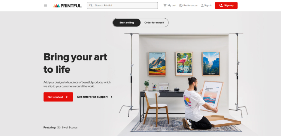 Printful homepage showing custom wall art and framed prints being prepared for print on demand orders